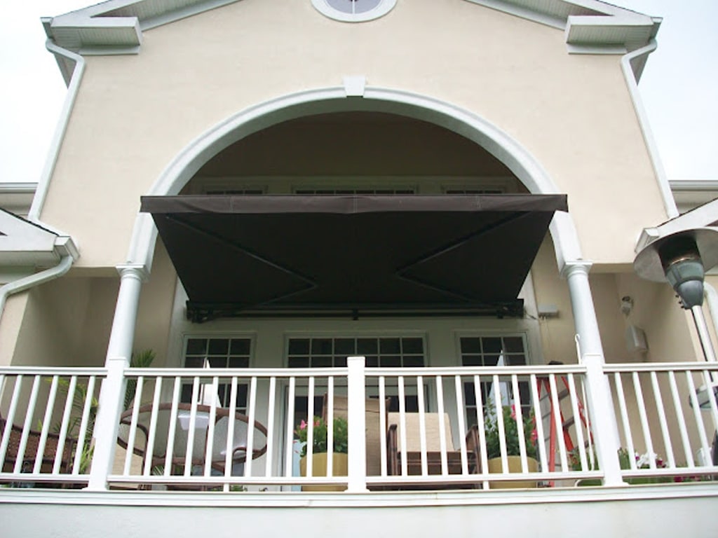 residential-retractable-awning-17 JoDiMor - About JoDiMor - Specialists in Awnings, Shades, Blinds & More - residential exterior with brown awning over porch